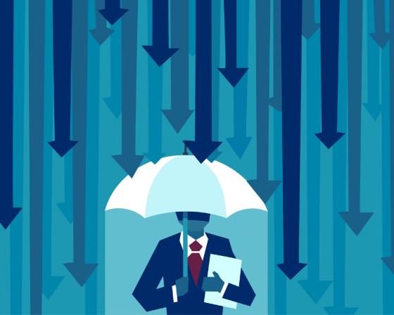 Businessman with umbrella protecting himself from falling arrows